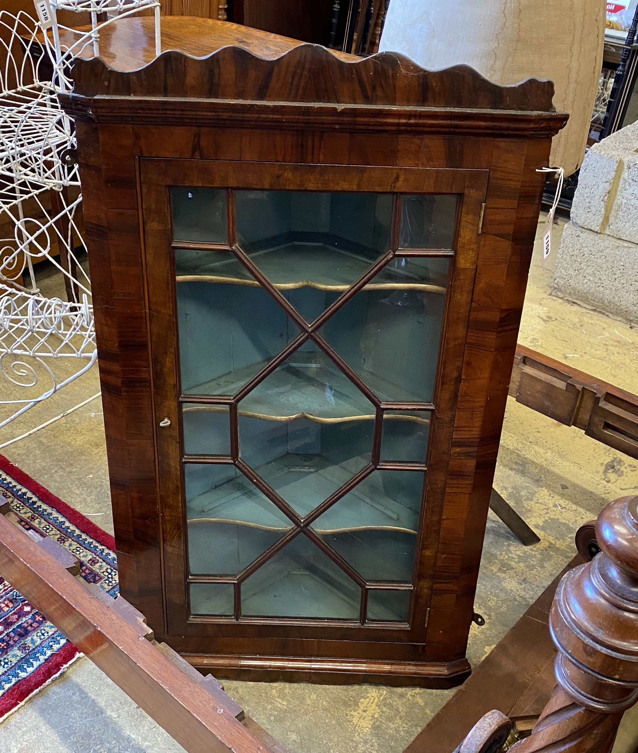 A George III walnut hanging corner cabinet, width 60cm, depth 28cm, height 102cm